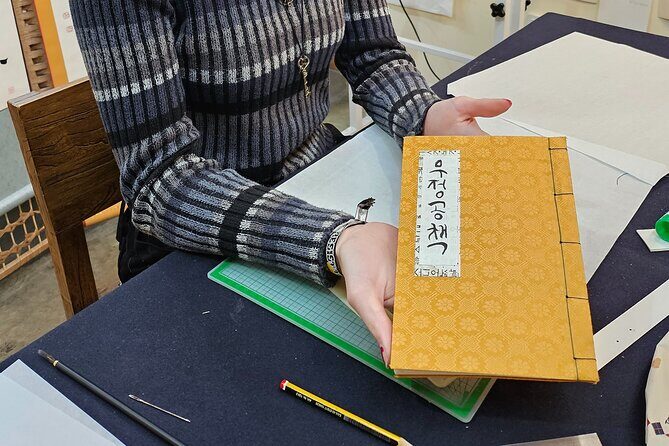 Create a Handmade Traditional Korean Notebook in Insadong - Stitching the binding: holes, needle, and thread
